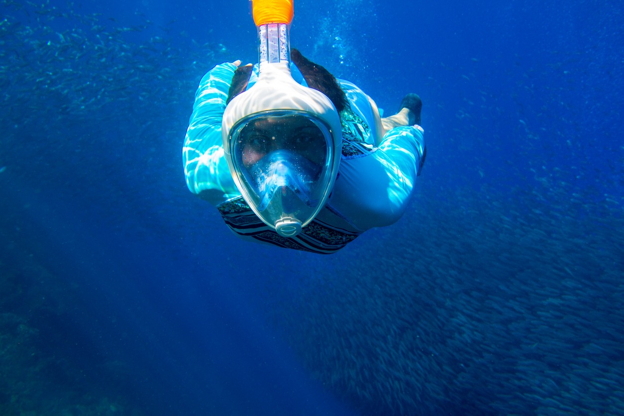 Girl snorkeling in full-face mask