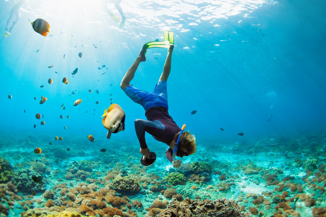 Young man in snorkelling mask dive underwater