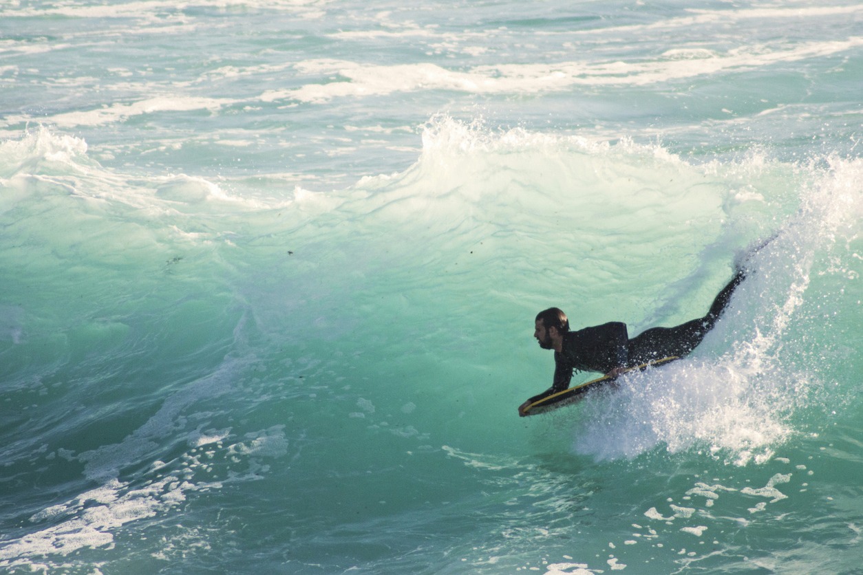 One Man Surfing In Sea