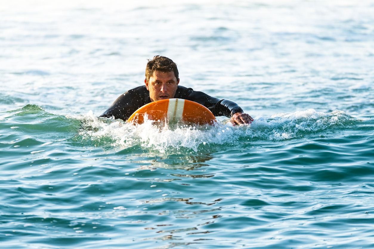 Surfer on longboard over the water