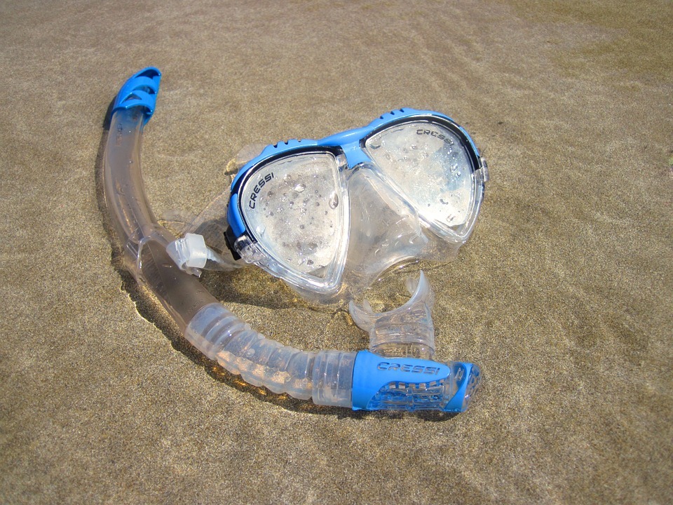 a snorkeling mask on the beach