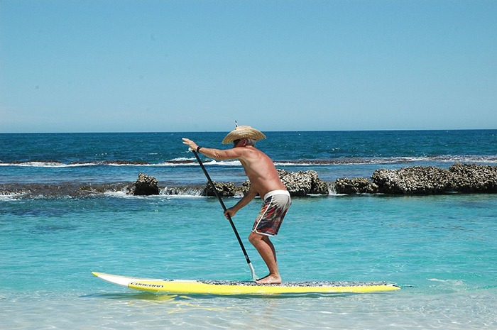 a man on a stand up paddle board