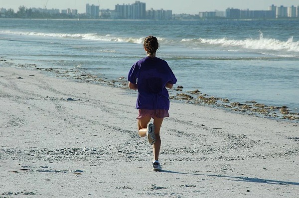 woman jogging by the beach