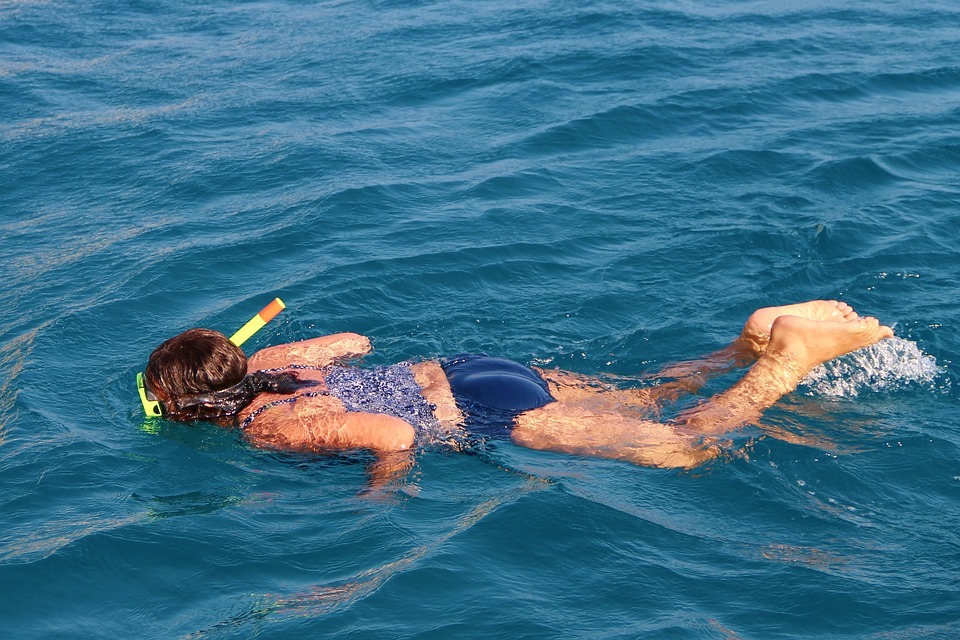 woman snorkeling in the ocean: