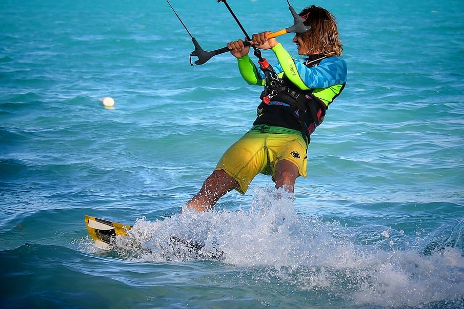 A wakeboarder wearing a wet suit top