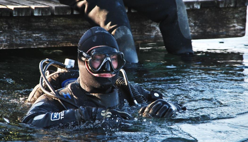 A person wearing a wetsuit and gear