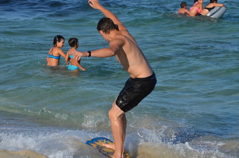 A skimboarder learning how to balance the board