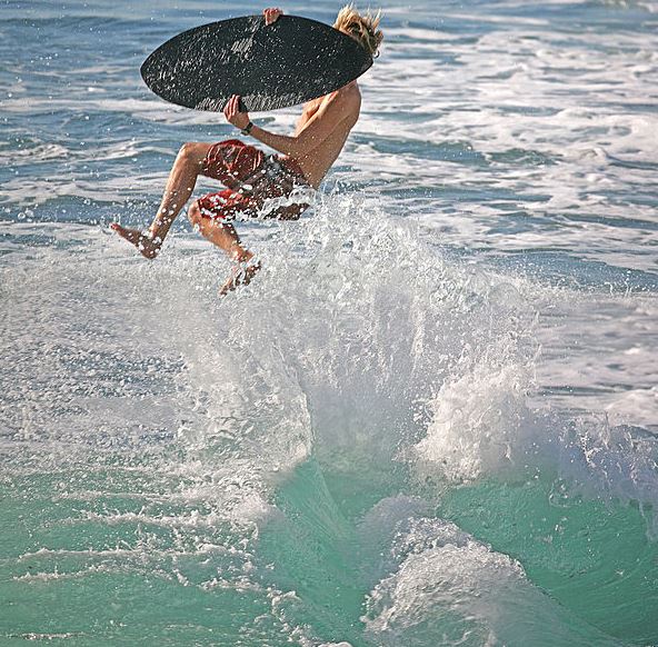 A skimboarder performing a trick
