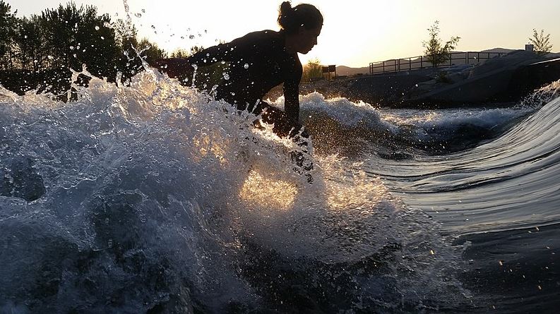 A woman in Boise river surfing