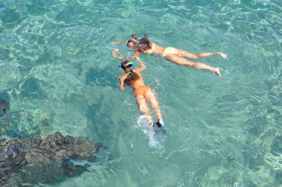 Mother and daughter snorkeling together