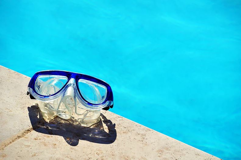 Snorkel goggles by the edge of the pool