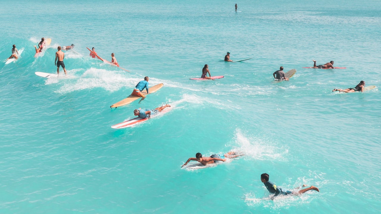 seventeen people paddling and riding their bodyboards